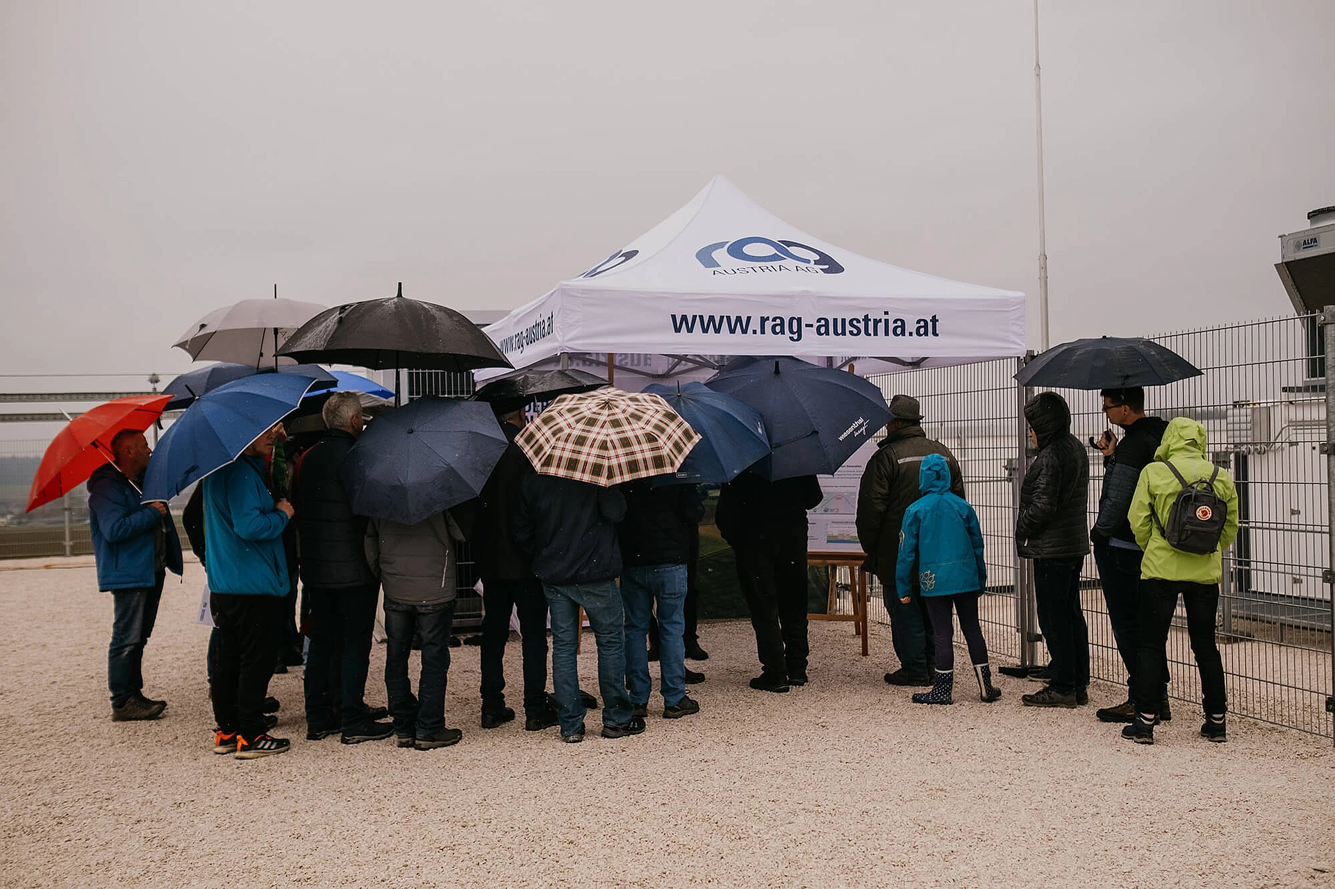 Visitors with umbrellas at residents and information day